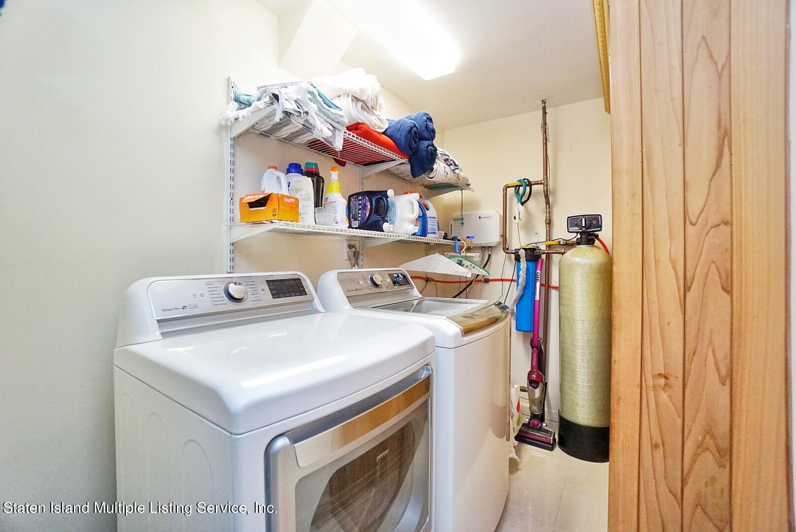 67 Covington Circle Staten Island, NY 10312 - Photo 44 of 45 a utility room with dryer and washer