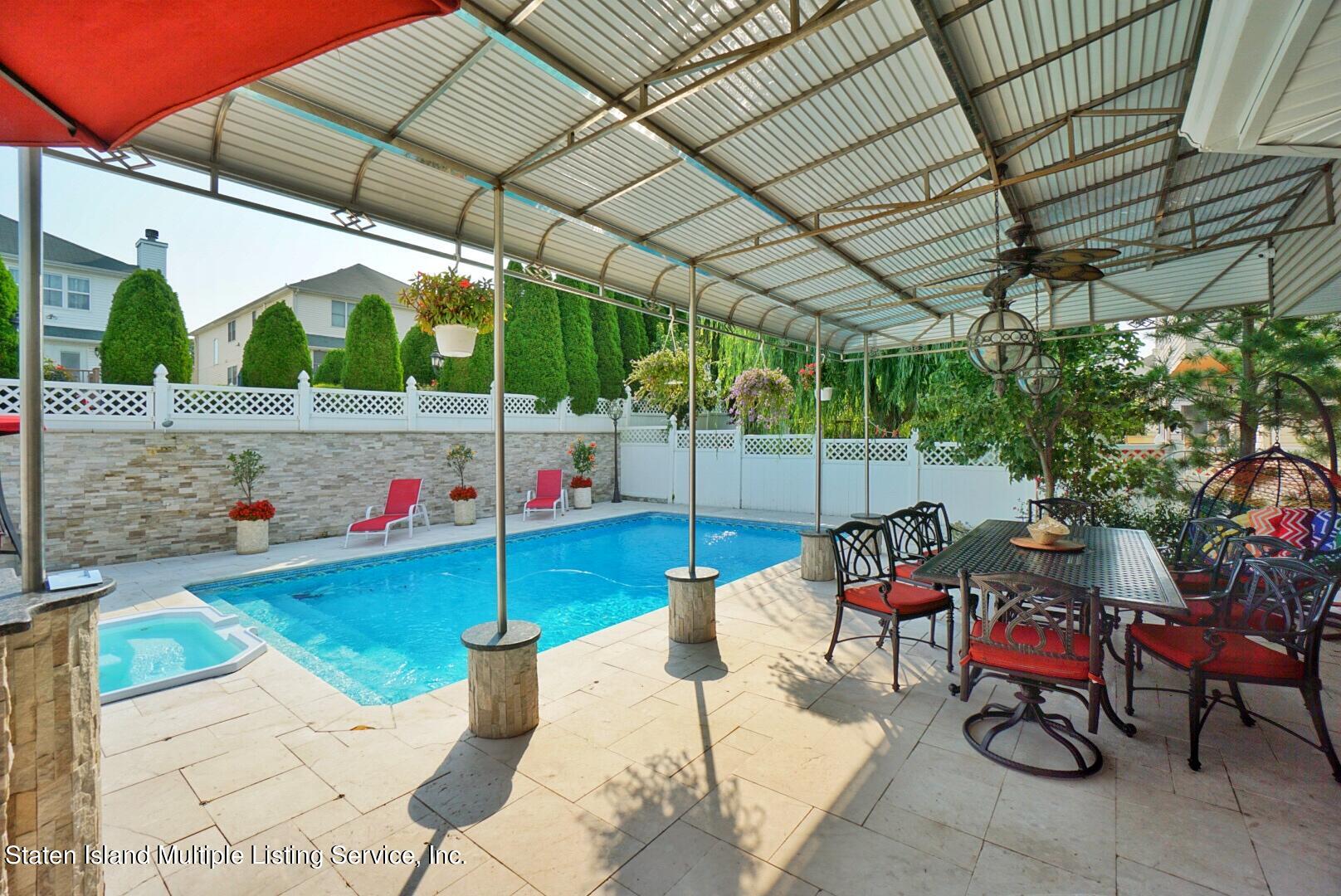 67 Covington Circle Staten Island, NY 10312 - Photo 5 of 45 a view of patio with table and chairs potted plants