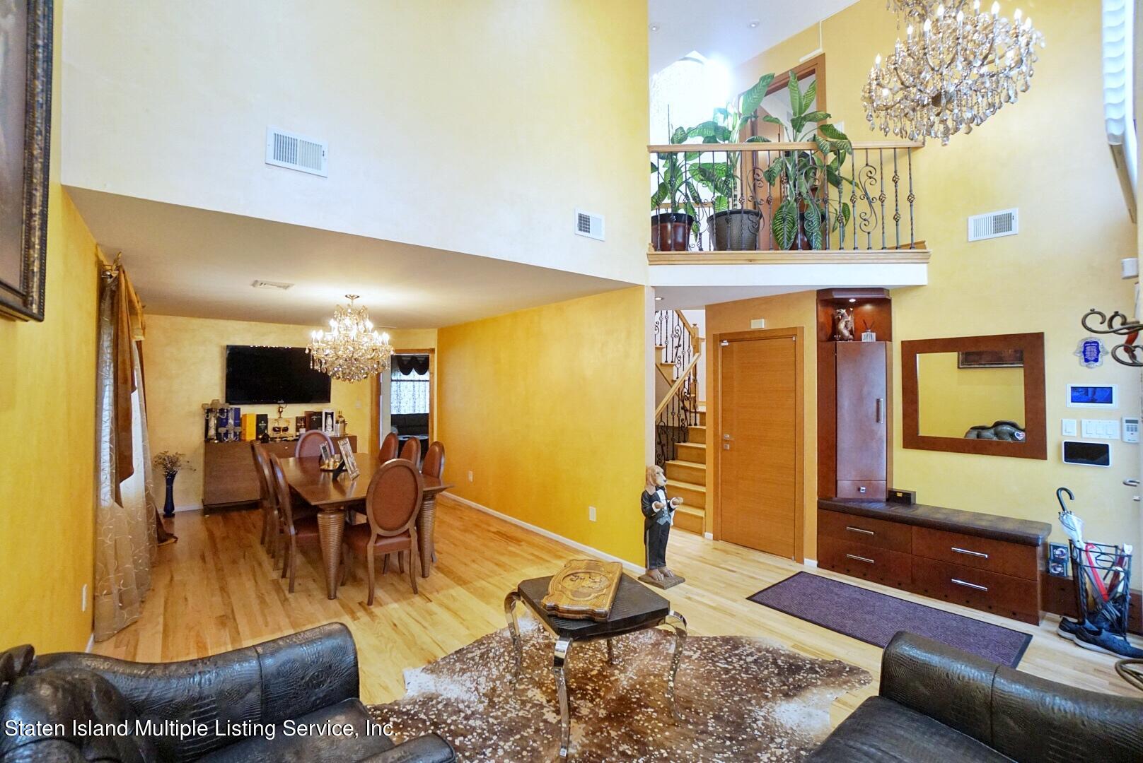 67 Covington Circle Staten Island, NY 10312 - Photo 9 of 45 a living room with fireplace furniture and a table