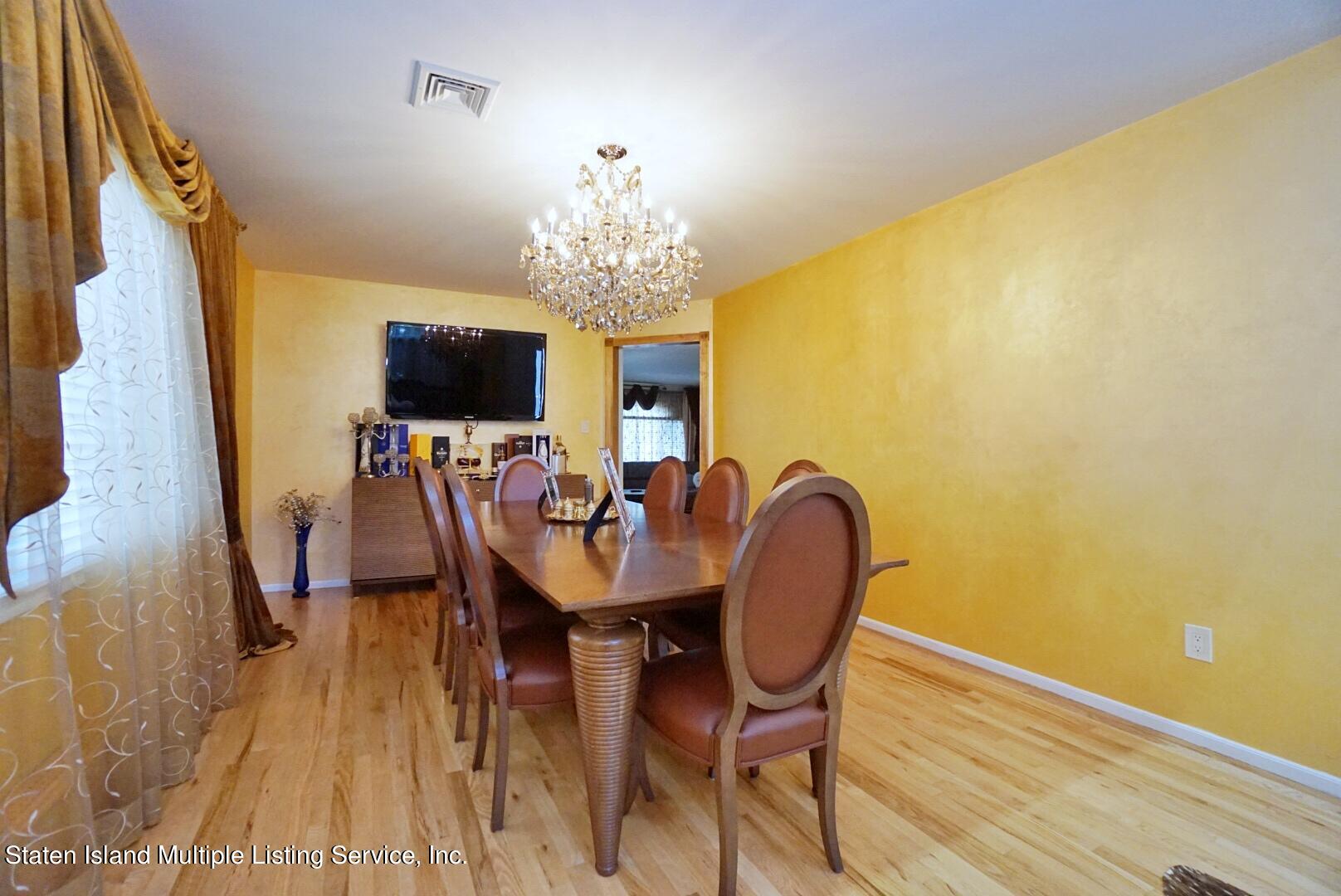 67 Covington Circle Staten Island, NY 10312 - Photo 10 of 45 a view of a dining room with furniture and a chandelier