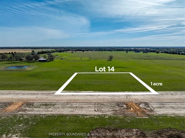 a view of a field with an ocean view