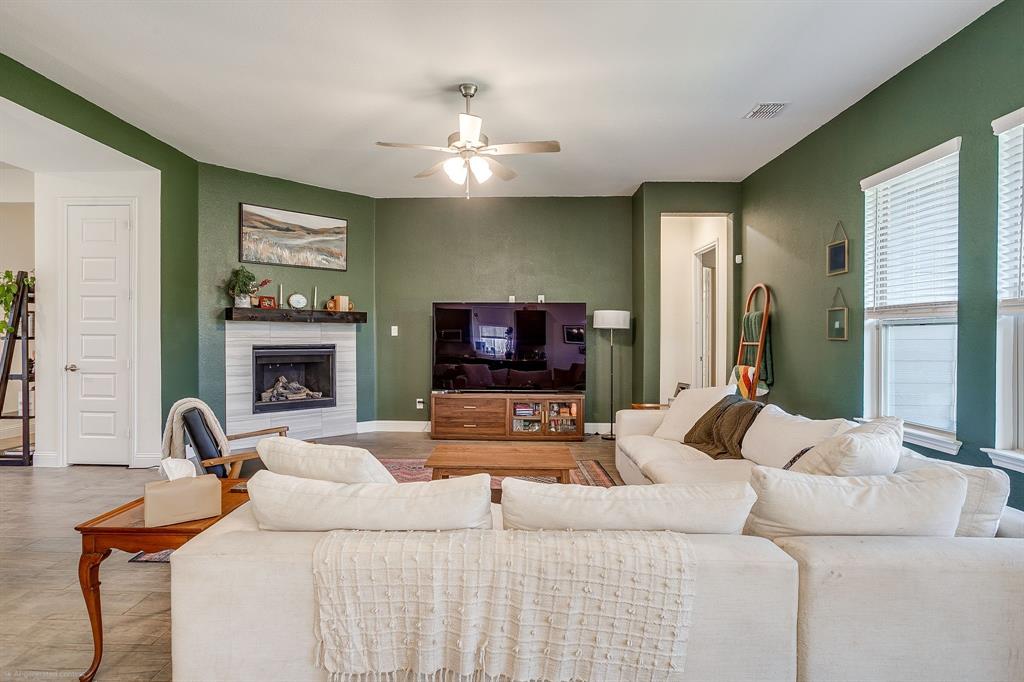 3929 Brookdale Road Benbrook, TX 76116 - Photo 16 of 39 a living room with furniture a fireplace and a flat screen tv