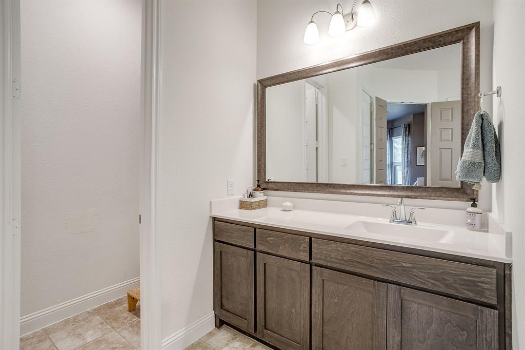 3929 Brookdale Road Benbrook, TX 76116 - Photo 26 of 39 a bathroom with a double vanity sink and a mirror