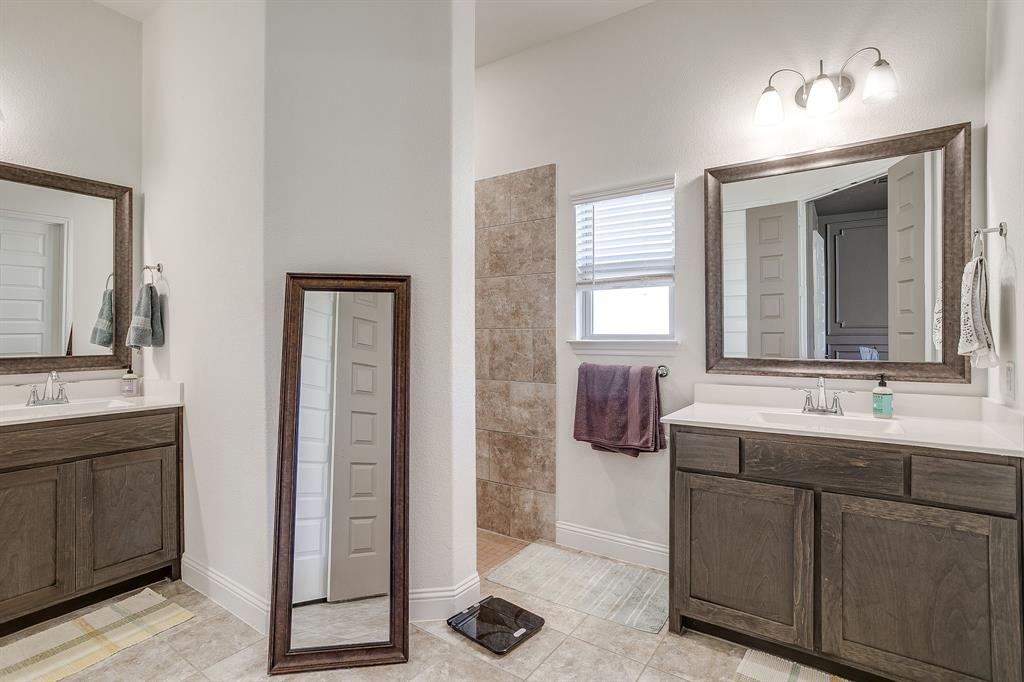 3929 Brookdale Road Benbrook, TX 76116 - Photo 30 of 39 a bathroom with a double vanity sink a mirror and a shower