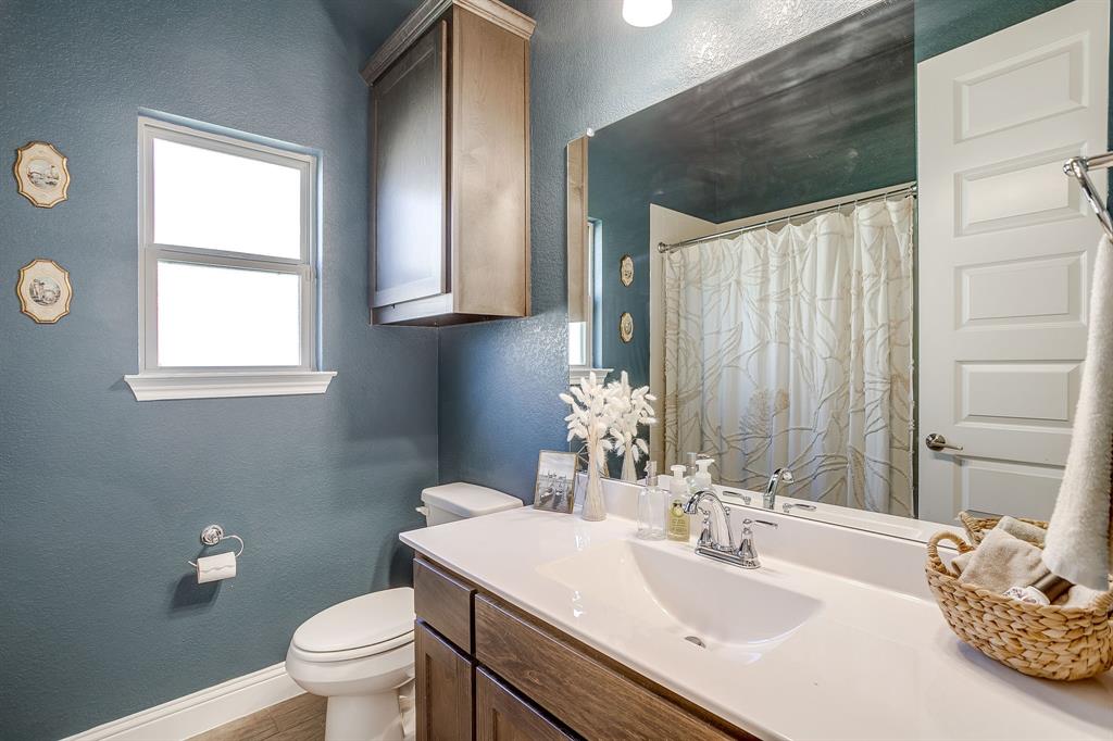 3929 Brookdale Road Benbrook, TX 76116 - Photo 34 of 39 a bathroom with a sink toilet and vanity