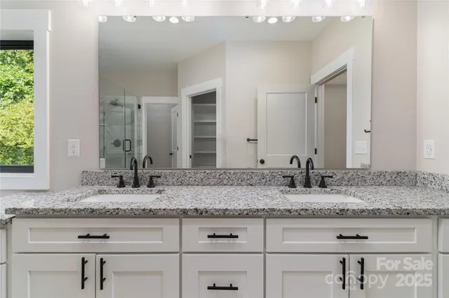 a bathroom with sink granite and a mirror