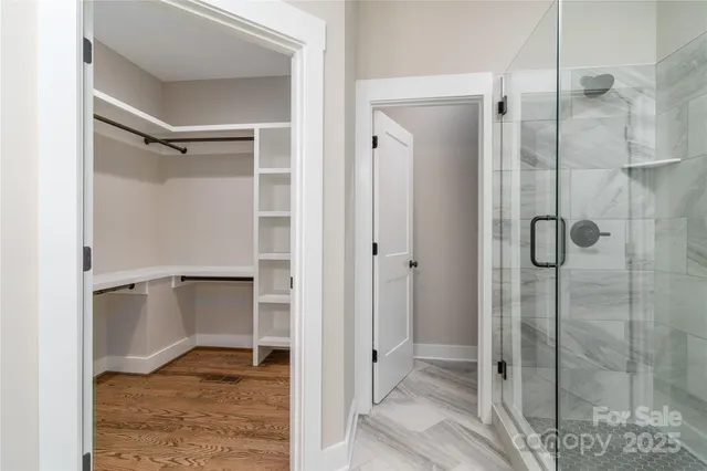a bathroom with a shower and a glass door