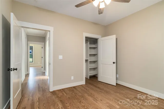 wooden floor in an empty room and a bathroom