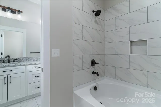 a bathroom with a bathtub and a sink