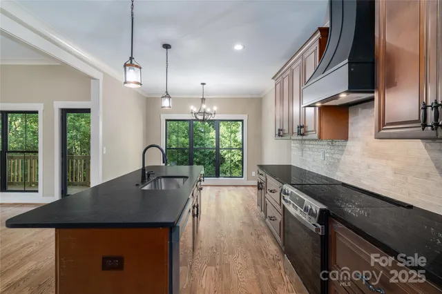 a kitchen with kitchen island a counter space a sink and appliances
