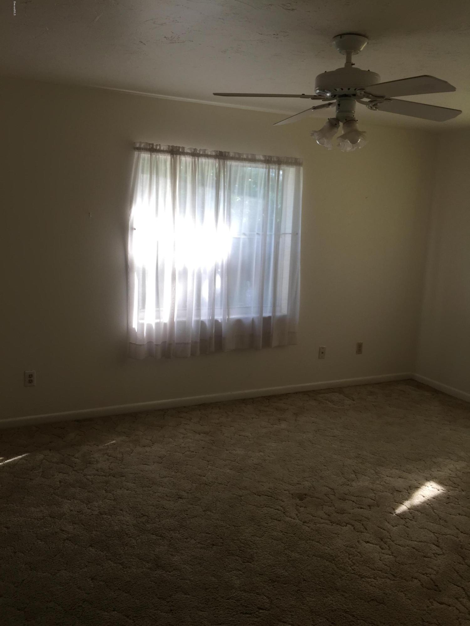 2402 Allan Adale Road Melbourne, FL 32935 - Photo 14 of 23 a view of an empty room and window