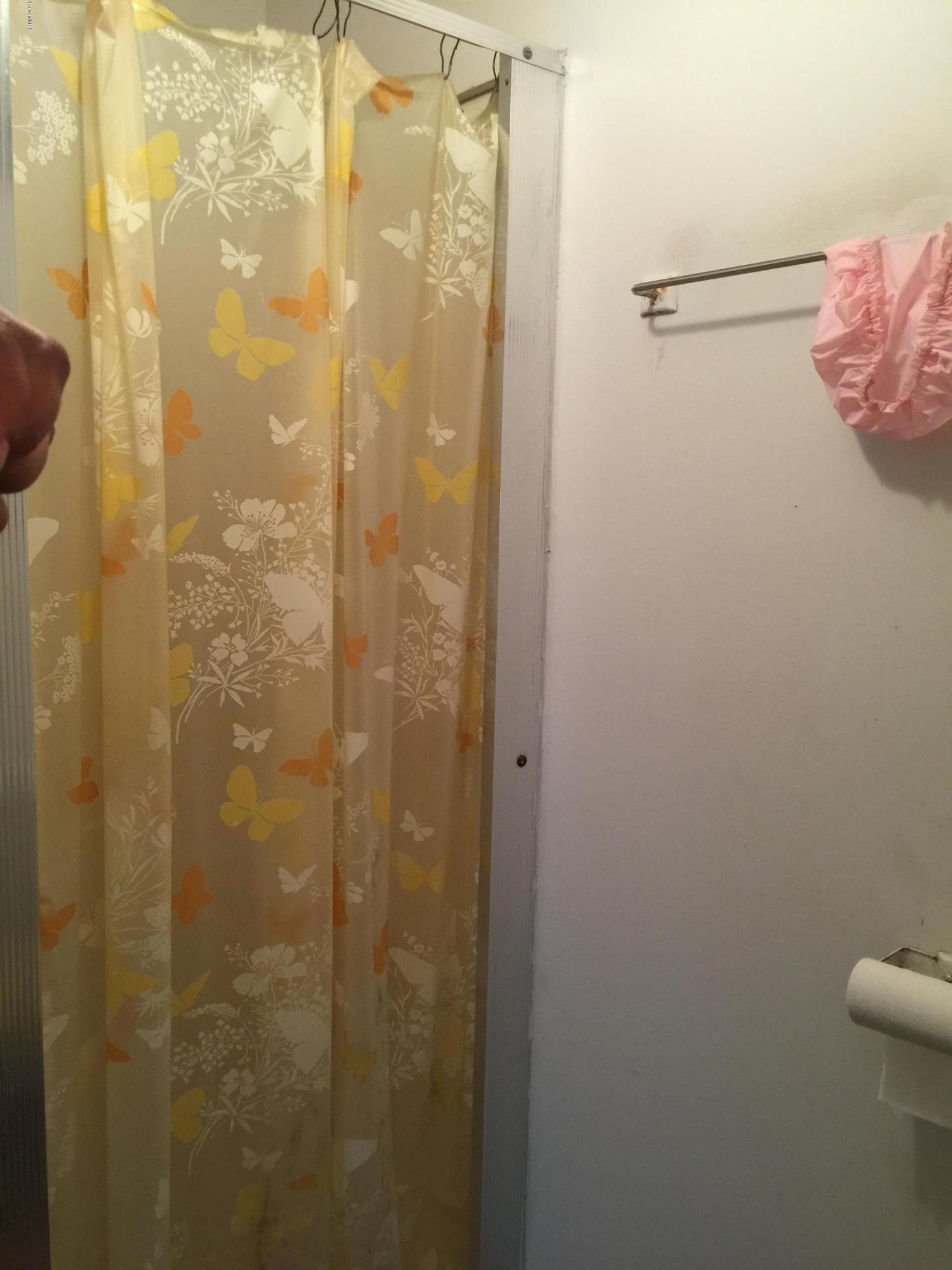 2402 Allan Adale Road Melbourne, FL 32935 - Photo 17 of 23 a bathroom with a shower