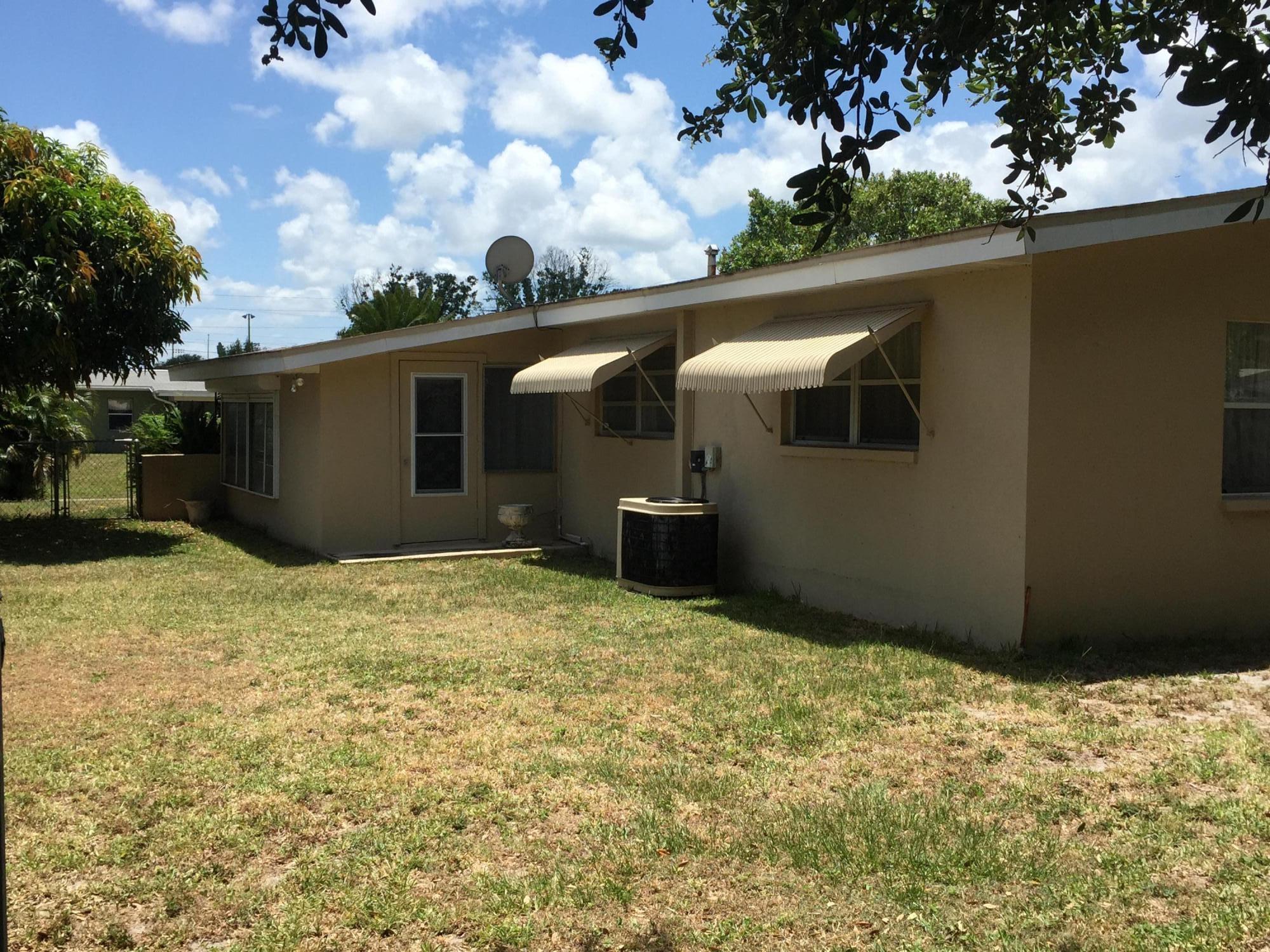 2402 Allan Adale Road Melbourne, FL 32935 - Photo 20 of 23 a backyard of a house with lots of green space