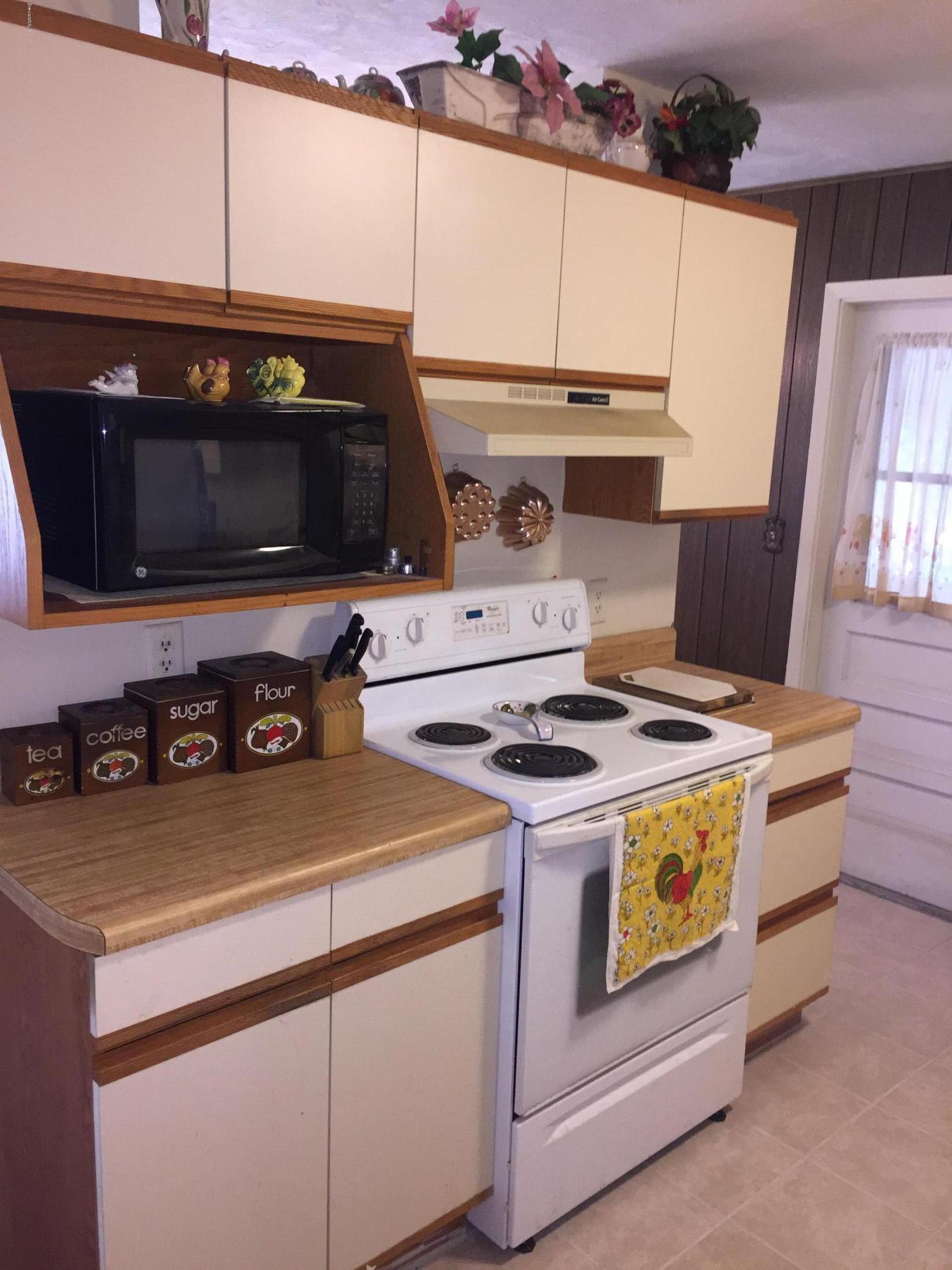 2402 Allan Adale Road Melbourne, FL 32935 - Photo 3 of 23 a stove top oven sitting inside of a kitchen