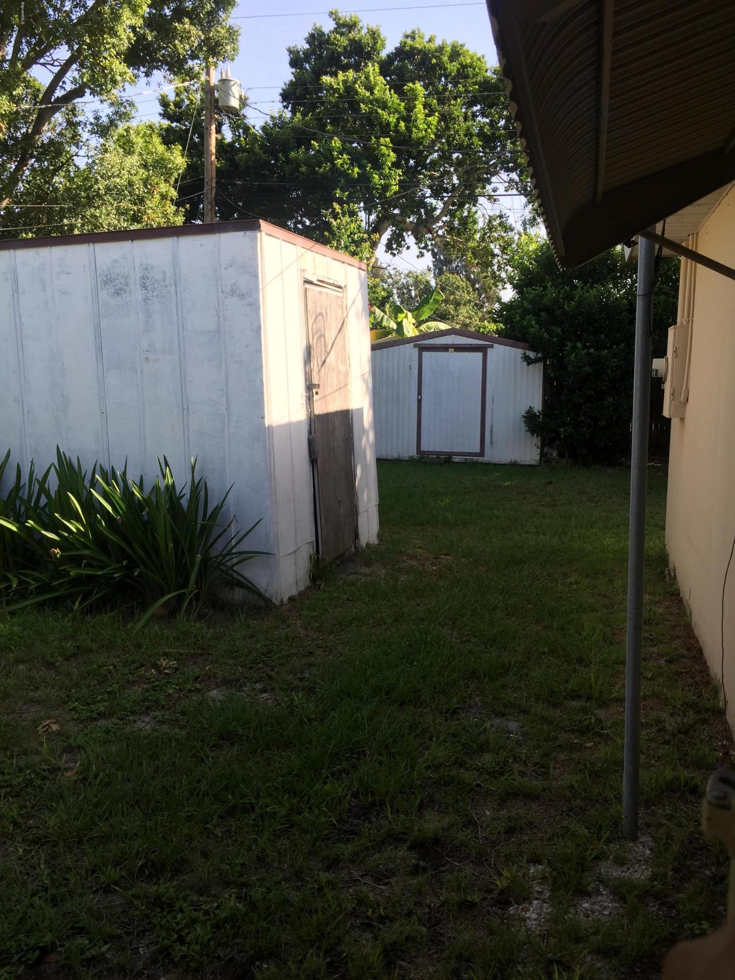 2402 Allan Adale Road Melbourne, FL 32935 - Photo 22 of 23 a backyard space with tall trees