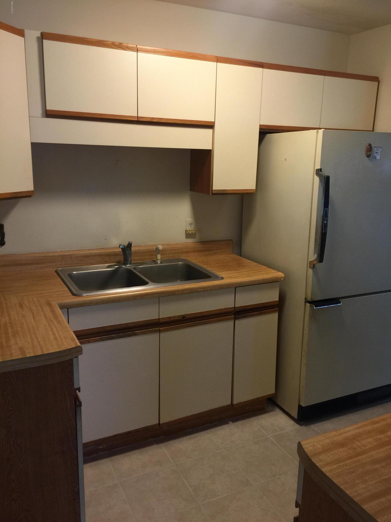 2402 Allan Adale Road Melbourne, FL 32935 - Photo 4 of 23 a kitchen with a sink and a refrigerator