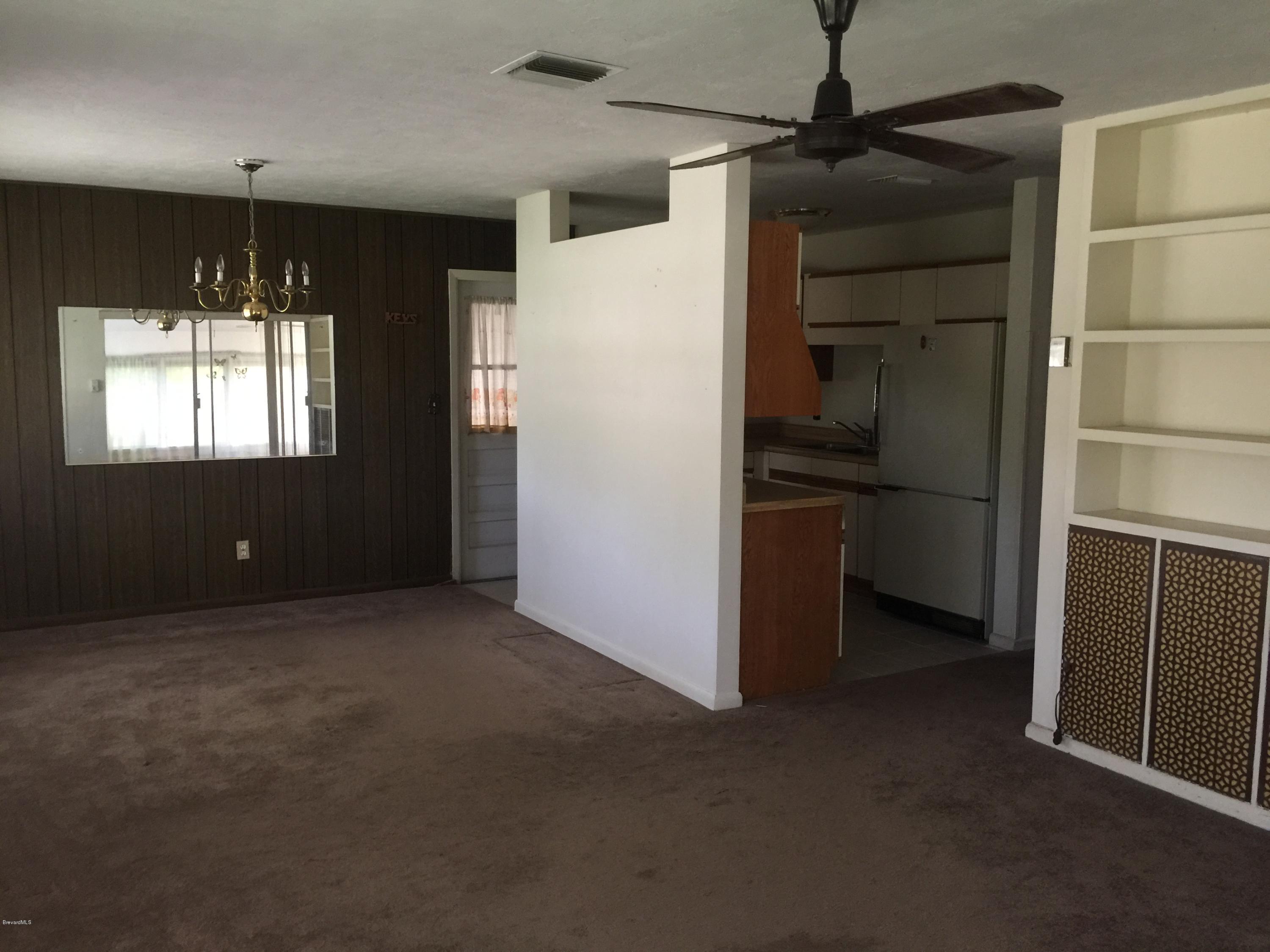 2402 Allan Adale Road Melbourne, FL 32935 - Photo 7 of 23 a view of empty room with windows and refrigerator