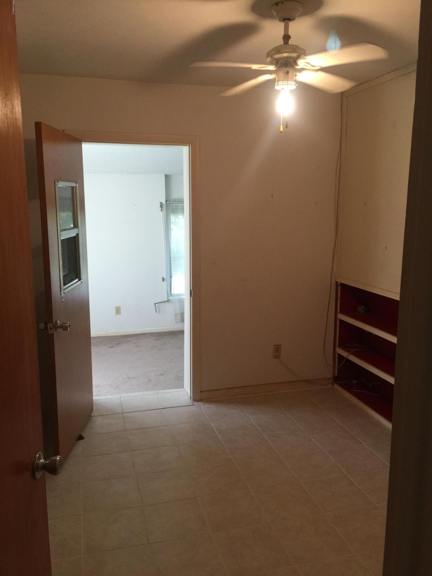 2402 Allan Adale Road Melbourne, FL 32935 - Photo 10 of 23 wooden floor in an empty room