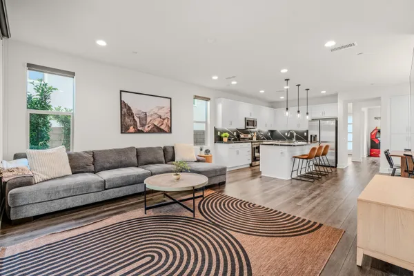 a living room with furniture and kitchen view