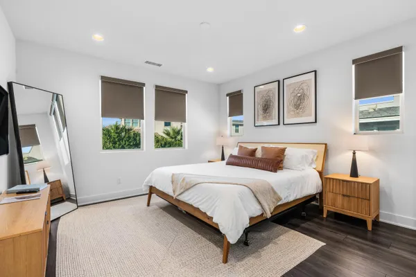 a bedroom with a large bed and a flat screen tv
