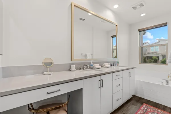 a bathroom with a double vanity sink and a mirror