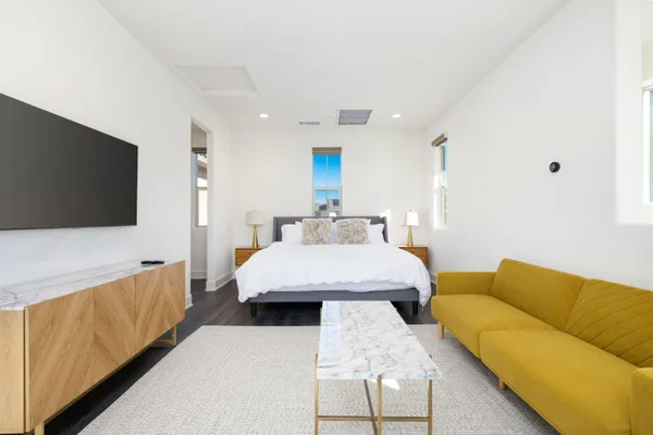 a bedroom with a bed and a flat screen television