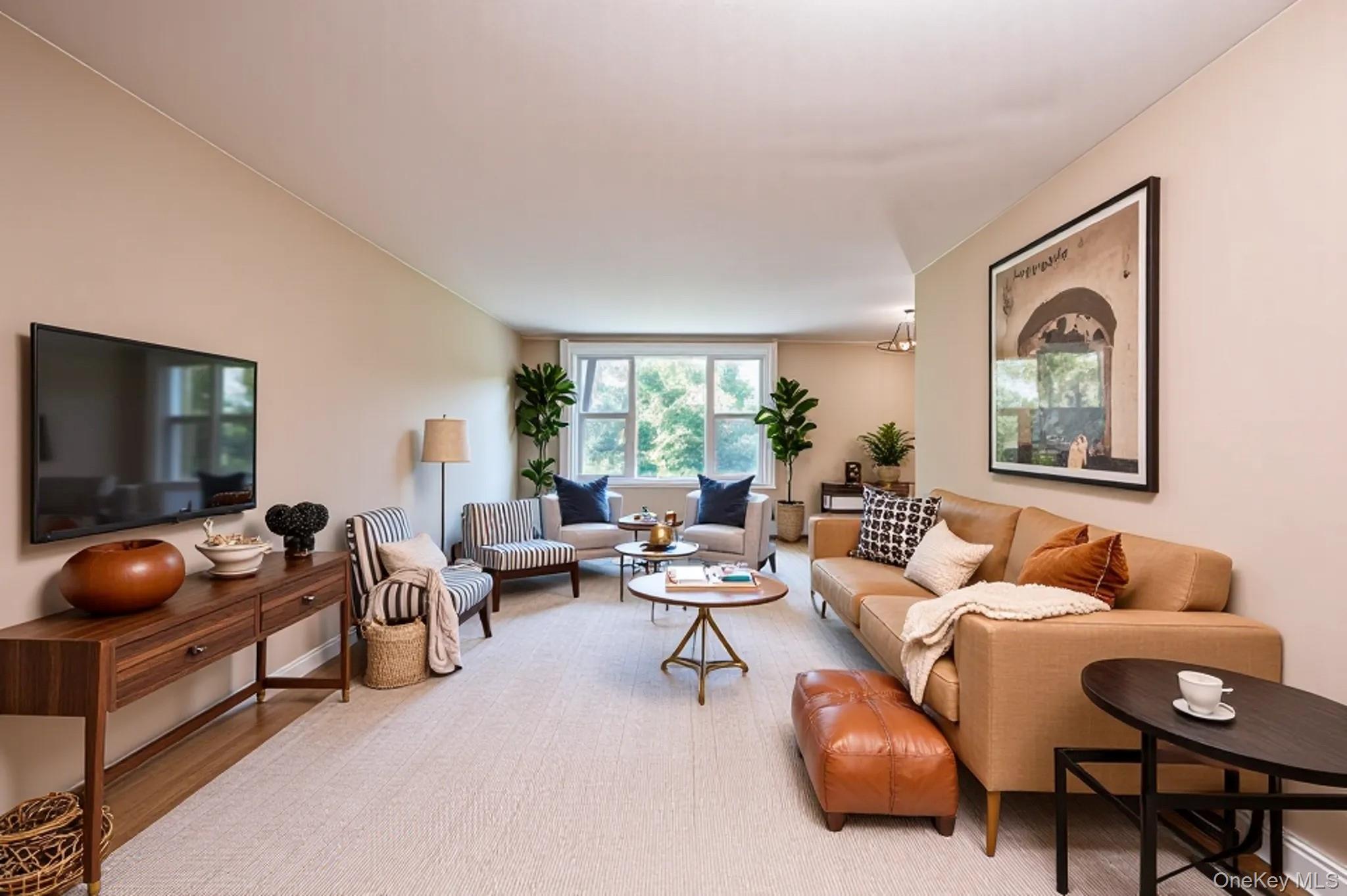 Living area with baseboards and wood finished floors
