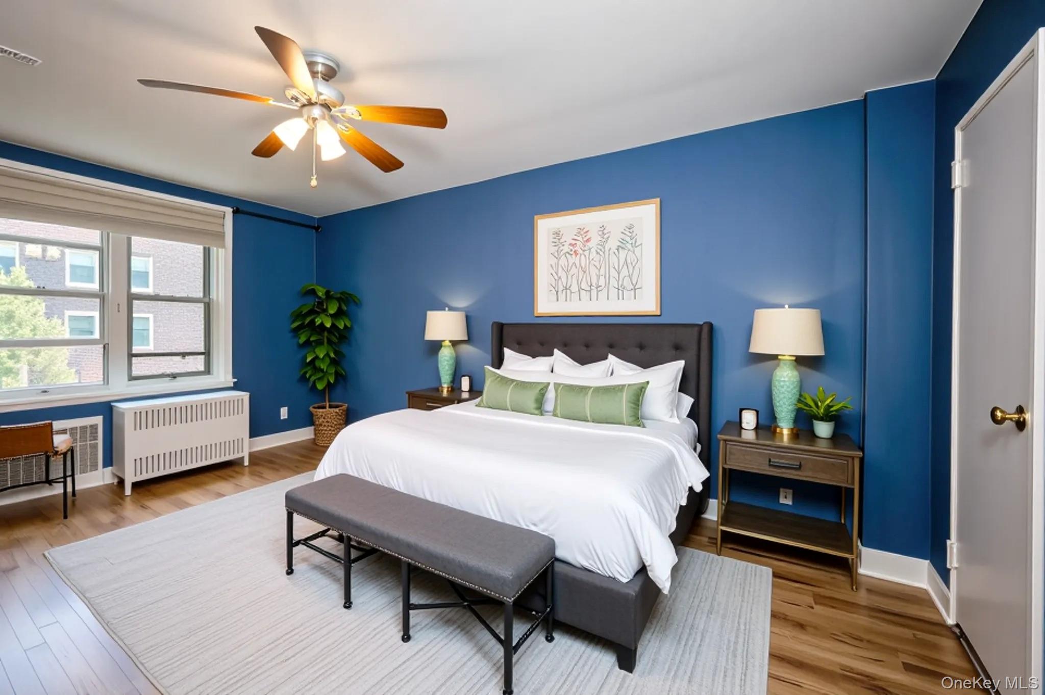 120 Dehaven Drive, Unit 629 Yonkers, NY 10703 - Photo 6 of 12 Bedroom featuring radiator, wood finished floors, and ceiling fan