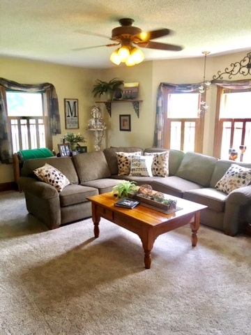 6166 Ogle Road Polo, IL 61064 - Photo 15 of 32 a living room with furniture and a chandelier