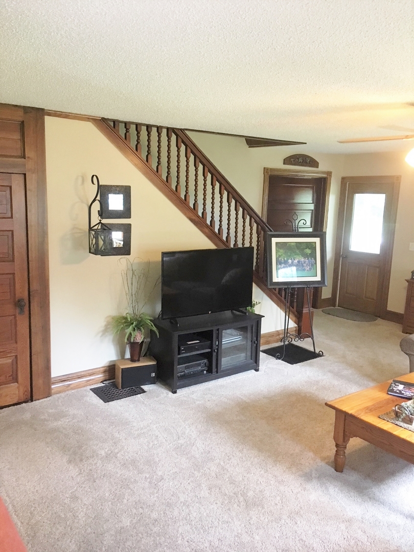 6166 Ogle Road Polo, IL 61064 - Photo 22 of 32 a living room with furniture and a flat screen tv