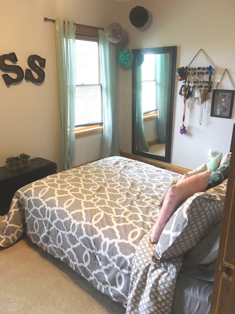 6166 Ogle Road Polo, IL 61064 - Photo 25 of 32 a bedroom with a bed and dresser with mirror