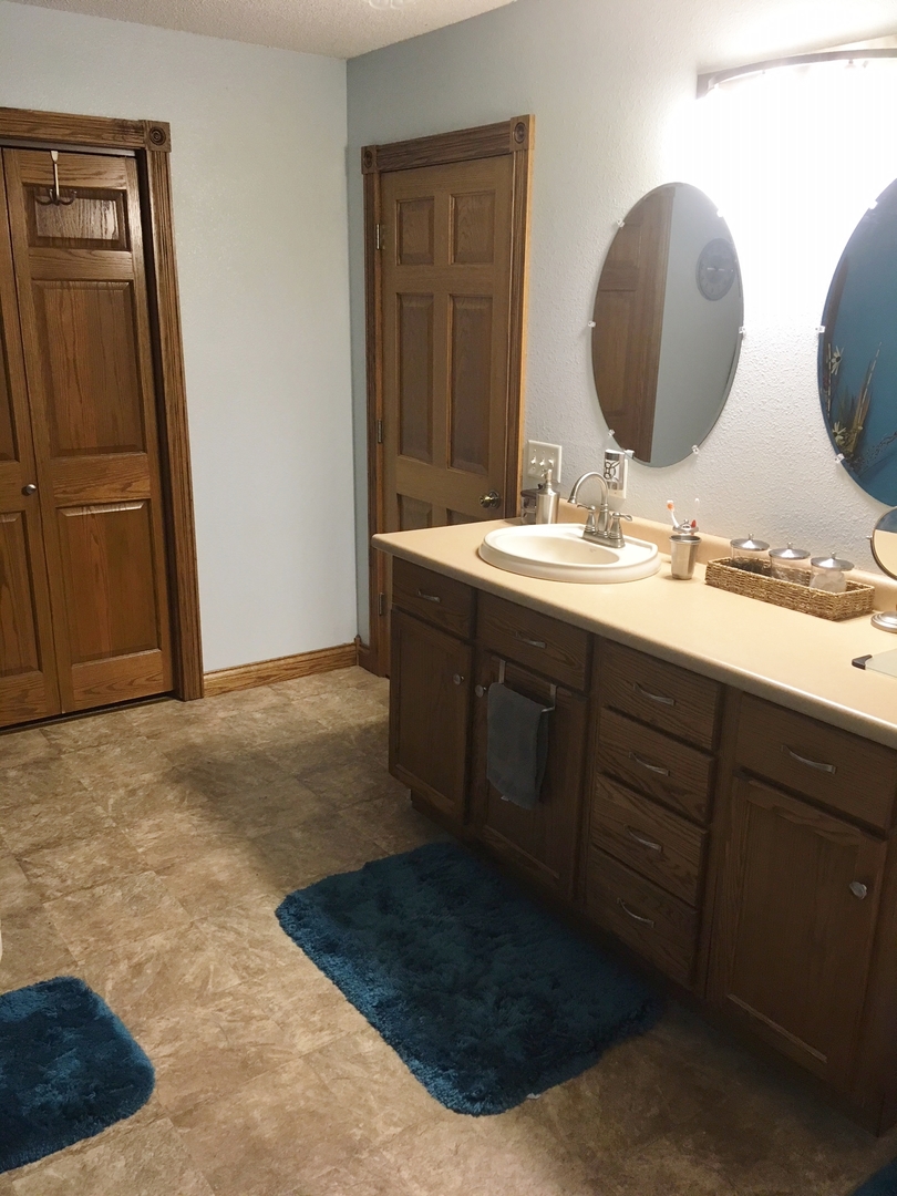 6166 Ogle Road Polo, IL 61064 - Photo 30 of 32 a bathroom with a double vanity sink and mirror