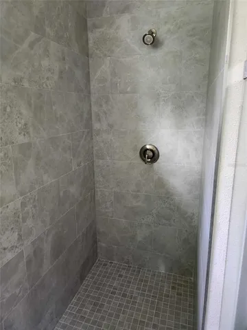 a bathroom with a glass shower door