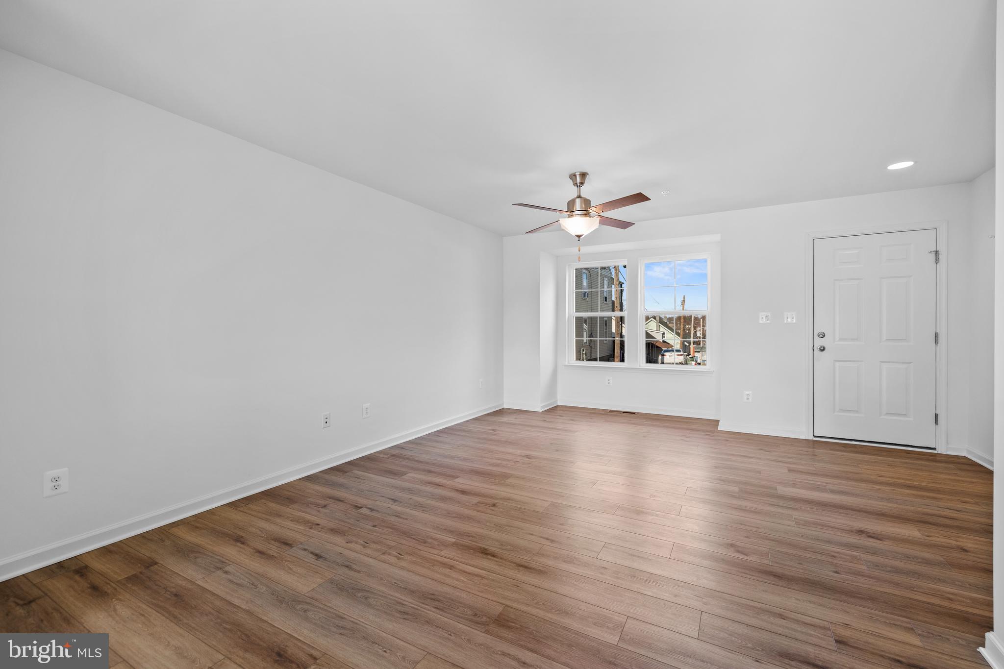487 Peleton Street Hagerstown, MD 21740 - Photo 6 of 27 wooden floor in an empty room with a window