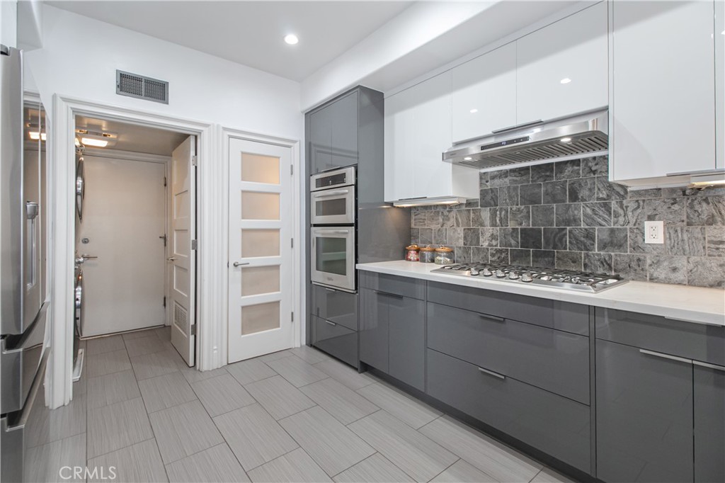 23057 Park Este Calabasas, CA 91302 - Photo 14 of 31 a kitchen with cabinets and window
