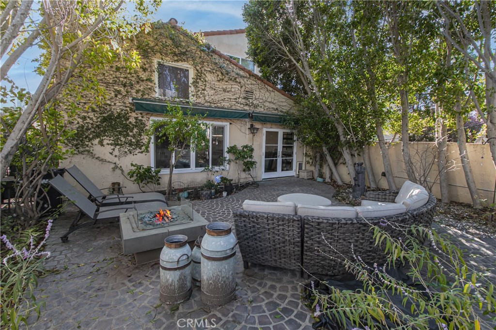 23057 Park Este Calabasas, CA 91302 - Photo 4 of 31 a view of a patio with table and chairs potted plants and large tree