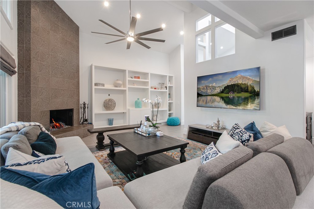 23057 Park Este Calabasas, CA 91302 - Photo 7 of 31 a living room with furniture ceiling fan and a fireplace