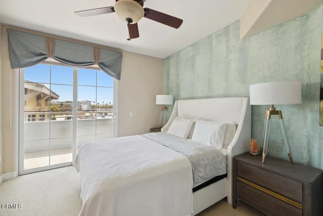 a bedroom with a bed and a glass walk in closet