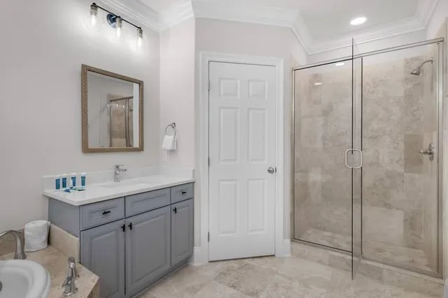 a bathroom with a shower sink vanity and mirror