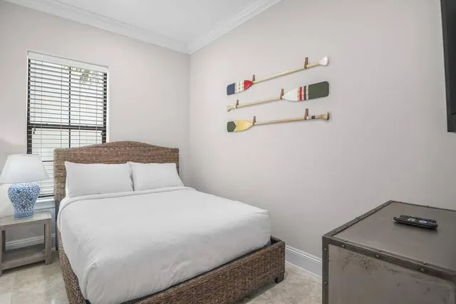 a bedroom with a bed and a window