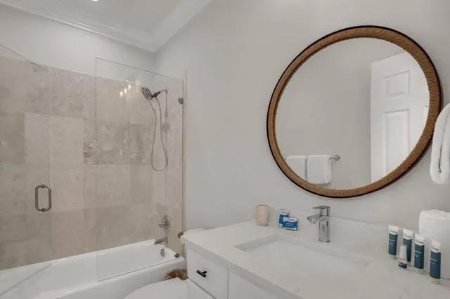 a bathroom with a sink a mirror and a bathtub
