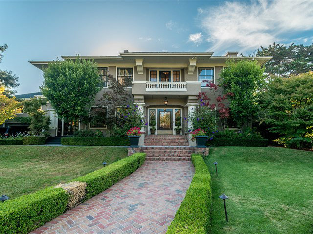 a front view of a house with a yard
