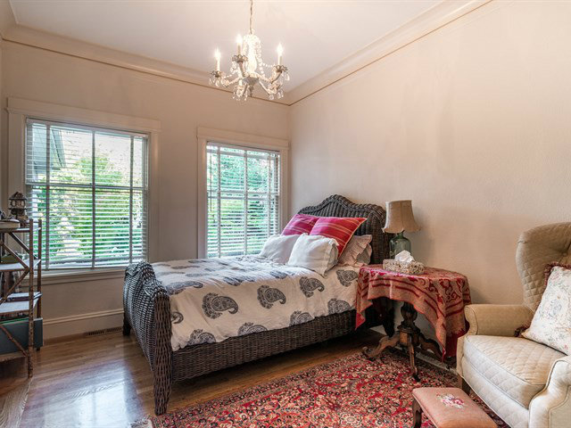 224 Warren Road San Mateo, CA 94402 - Photo 18 of 25 a bedroom with a bed and a chandelier