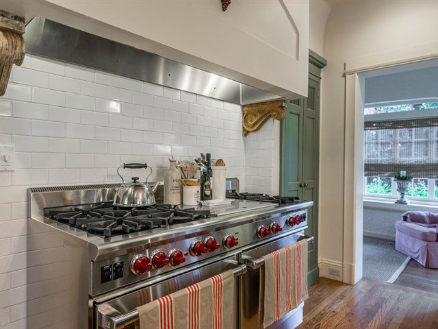 224 Warren Road San Mateo, CA 94402 - Photo 7 of 25 a kitchen with stainless steel appliances granite countertop a stove and a wooden cabinets