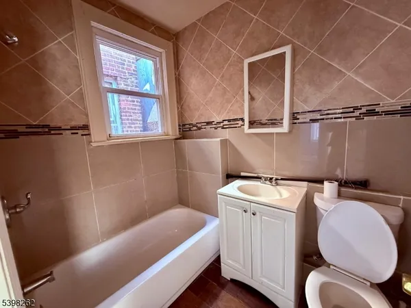 a bathroom with a sink a toilet and tub