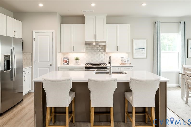 5 Driver Lane Richmond, VA 23223 - Photo 2 of 25 a kitchen with stainless steel appliances a white stove top oven and refrigerator