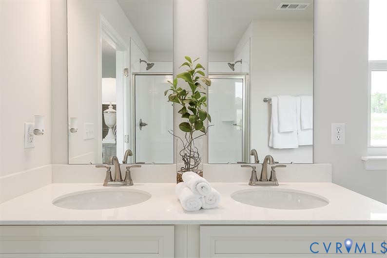 5 Driver Lane Richmond, VA 23223 - Photo 22 of 25 a bathroom with double vanity sinks and a mirror