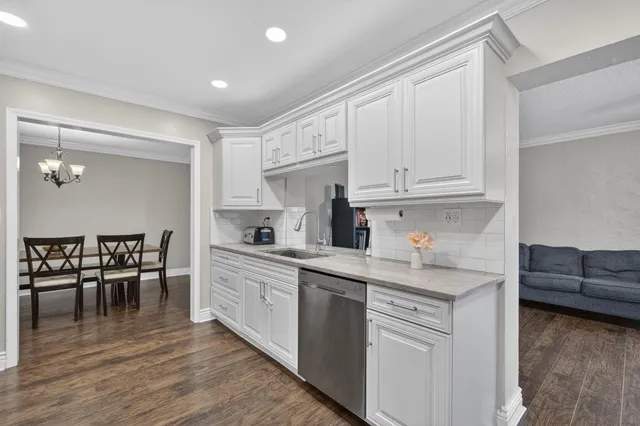 a kitchen with cabinets and chairs