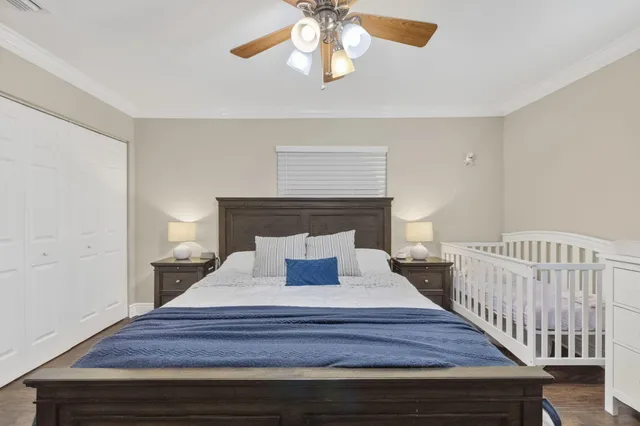 a bedroom with a bed and a chandelier