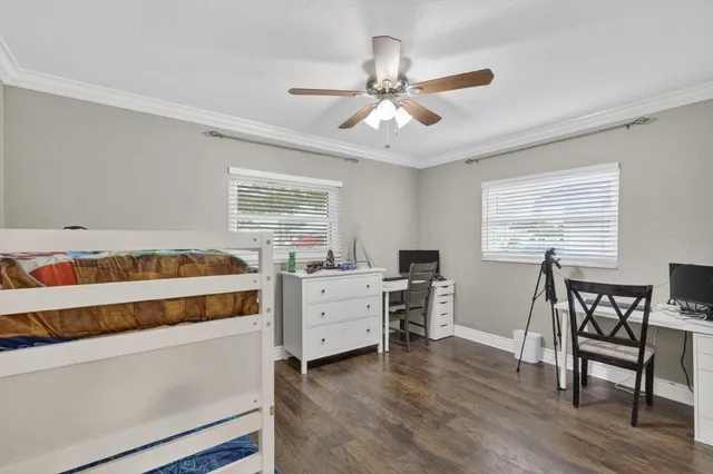 a bedroom with a bed and a table chair